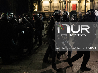 Police detain anti-government protesters during a ninth consecutive day of mass demonstrations against the government's postponement of Euro...