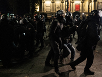 Police detain anti-government protesters during a ninth consecutive day of mass demonstrations against the government's postponement of Euro...