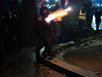 Police disperse anti-government protesters during a ninth consecutive day of mass demonstrations against the government's postponement of Eu...