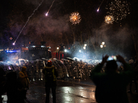 Anti-government protesters face police during a ninth consecutive day of mass demonstrations against the government's postponement of Europe...