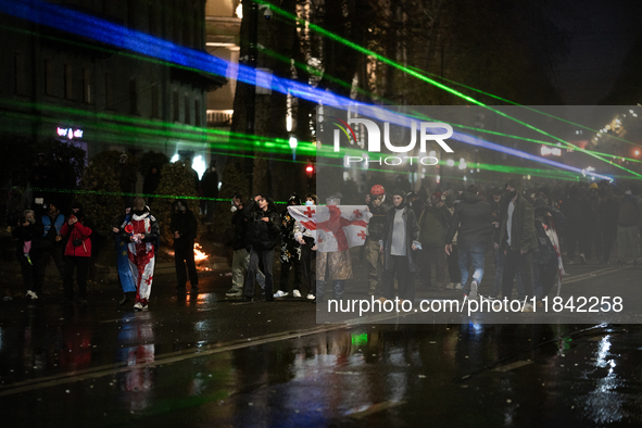 Anti-government protesters face police during a ninth consecutive day of mass demonstrations against the government's postponement of Europe...