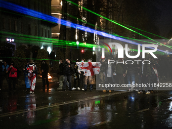 Anti-government protesters face police during a ninth consecutive day of mass demonstrations against the government's postponement of Europe...