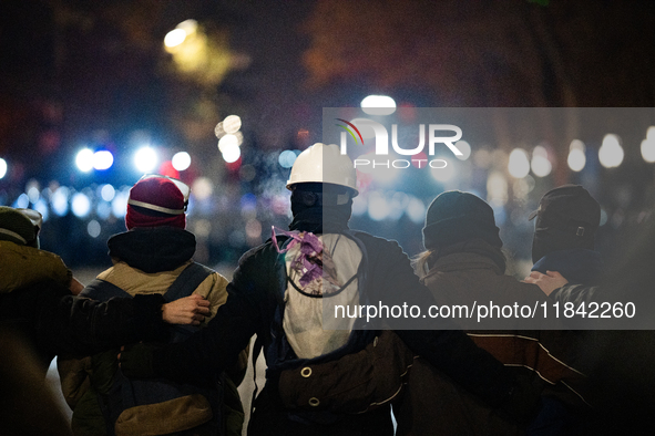 Anti-government protesters face police during a ninth consecutive day of mass demonstrations against the government's postponement of Europe...