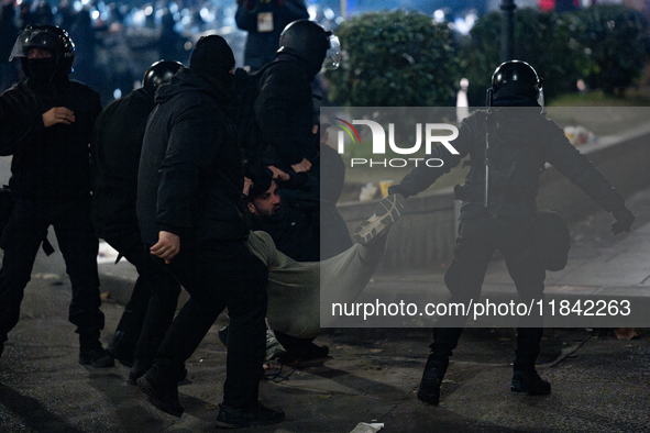 Police detain anti-government protesters during a ninth consecutive day of mass demonstrations against the government's postponement of Euro...