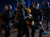 Police detain anti-government protesters during a ninth consecutive day of mass demonstrations against the government's postponement of Euro...