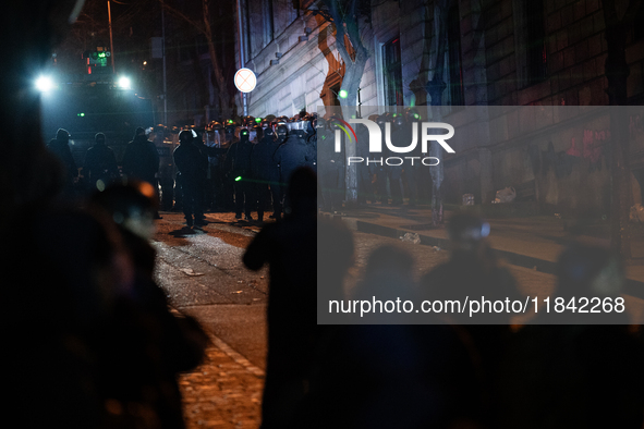 Anti-government protesters face police during a ninth consecutive day of mass demonstrations against the government's postponement of Europe...