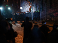 Anti-government protesters face police during a ninth consecutive day of mass demonstrations against the government's postponement of Europe...