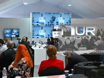 Media personnel inside the Media Centre watch a live telecast of Sheikh Mohammed bin Abdulrahman Al Thani, Prime Minister and Minister of Fo...