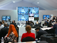 Media personnel inside the Media Centre watch a live telecast of Sheikh Mohammed bin Abdulrahman Al Thani, Prime Minister and Minister of Fo...