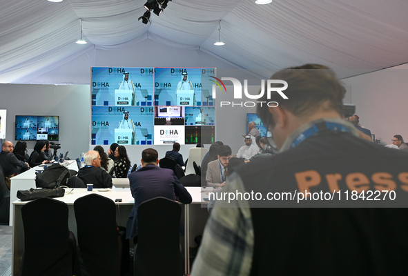 Media personnel inside the Media Centre watch a live telecast of Sheikh Mohammed bin Abdulrahman Al Thani, Prime Minister and Minister of Fo...