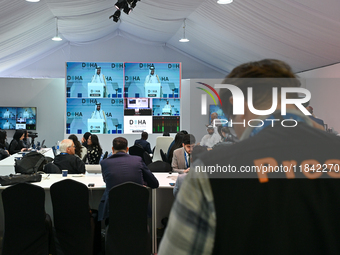 Media personnel inside the Media Centre watch a live telecast of Sheikh Mohammed bin Abdulrahman Al Thani, Prime Minister and Minister of Fo...