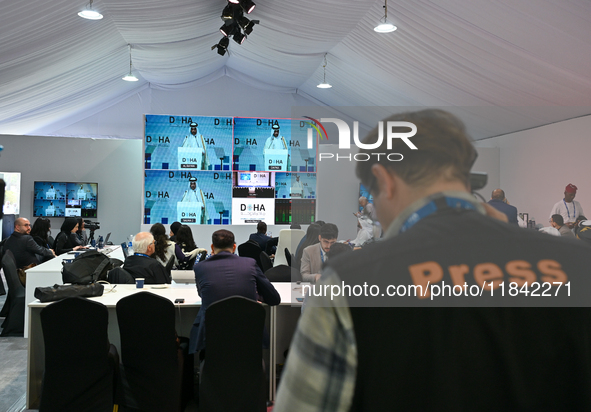 Media personnel inside the Media Centre watch a live telecast of Sheikh Mohammed bin Abdulrahman Al Thani, Prime Minister and Minister of Fo...