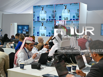 Media personnel inside the Media Centre watch a live telecast of Sheikh Mohammed bin Abdulrahman Al Thani, Prime Minister and Minister of Fo...