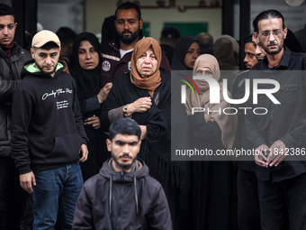 Palestinian women mourn relatives killed in an Israeli strike during their funeral at the al-Awda Hospital at the Nuseirat refugee Camp in t...