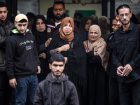 Palestinian women mourn relatives killed in an Israeli strike during their funeral at the al-Awda Hospital at the Nuseirat refugee Camp in t...