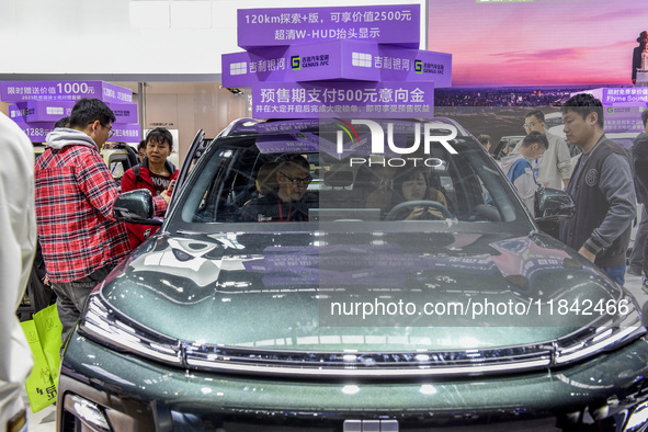 Visitors view Geely cars at the 2024 ASEAN International Auto Show in Nanning, China, on December 7, 2024. 