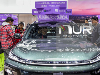 Visitors view Geely cars at the 2024 ASEAN International Auto Show in Nanning, China, on December 7, 2024. (