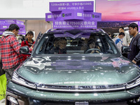 Visitors view Geely cars at the 2024 ASEAN International Auto Show in Nanning, China, on December 7, 2024. (