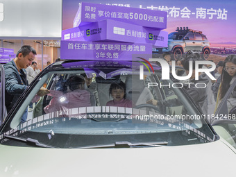 Visitors view Geely cars at the 2024 ASEAN International Auto Show in Nanning, China, on December 7, 2024. (