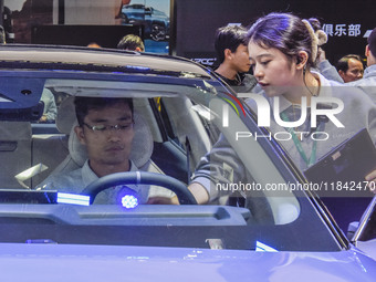 Visitors visit Lynk & Co 07EM-P at the 2024 ASEAN International Auto Show in Nanning, China, on December 7, 2024. (