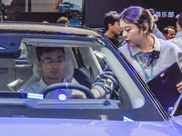 Visitors visit Lynk & Co 07EM-P at the 2024 ASEAN International Auto Show in Nanning, China, on December 7, 2024. (