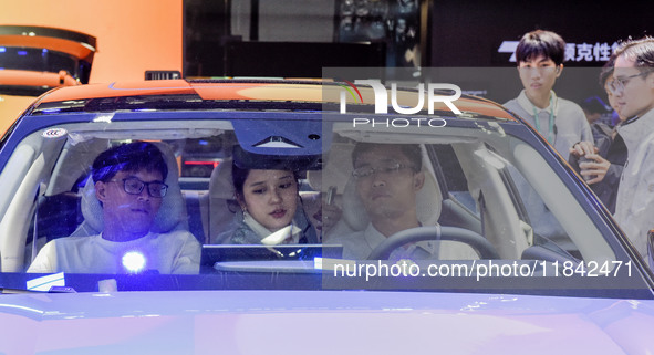 Visitors visit Lynk & Co 07EM-P at the 2024 ASEAN International Auto Show in Nanning, China, on December 7, 2024. 