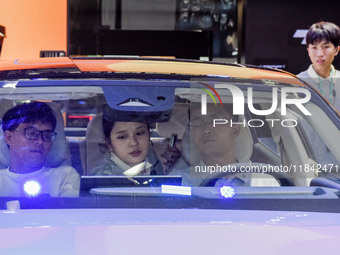 Visitors visit Lynk & Co 07EM-P at the 2024 ASEAN International Auto Show in Nanning, China, on December 7, 2024. (