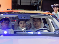 Visitors visit Lynk & Co 07EM-P at the 2024 ASEAN International Auto Show in Nanning, China, on December 7, 2024. (