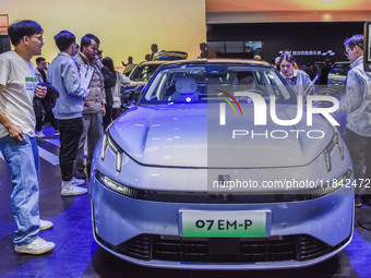 Visitors visit Lynk & Co 07EM-P at the 2024 ASEAN International Auto Show in Nanning, China, on December 7, 2024. (