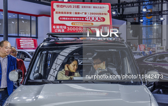 Visitors attend the 2024 ASEAN International Auto Show in Nanning, China, on December 7, 2024. 