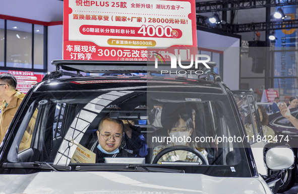 Visitors attend the 2024 ASEAN International Auto Show in Nanning, China, on December 7, 2024. 