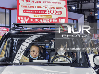 Visitors attend the 2024 ASEAN International Auto Show in Nanning, China, on December 7, 2024. (