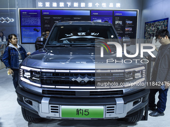 Visitors view a BYD Leopard 5 at the 2024 ASEAN International Auto Show in Nanning, China, on December 7, 2024. (