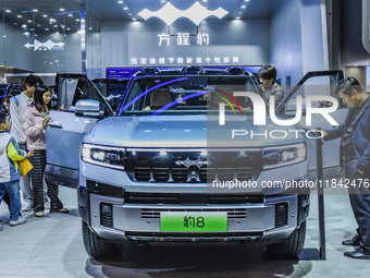 Visitors view a BYD Leopard 8 at the 2024 ASEAN International Auto Show in Nanning, China, on December 7, 2024. (