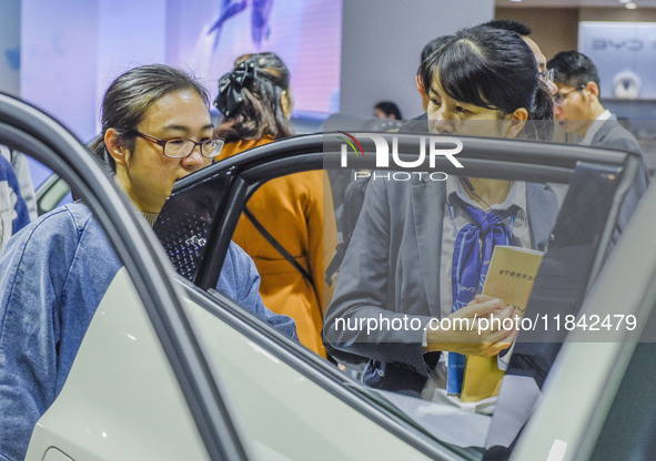 Visitors look at BYD's YANGWANG stand at the 2024 ASEAN International Auto Show in Nanning, China, on December 7, 2024. 