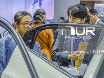 Visitors look at BYD's YANGWANG stand at the 2024 ASEAN International Auto Show in Nanning, China, on December 7, 2024. (