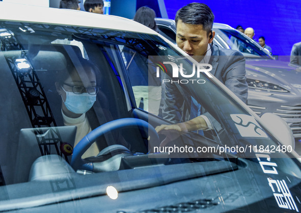 Visitors look at BYD's YANGWANG stand at the 2024 ASEAN International Auto Show in Nanning, China, on December 7, 2024. 