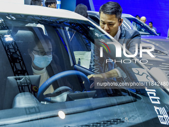 Visitors look at BYD's YANGWANG stand at the 2024 ASEAN International Auto Show in Nanning, China, on December 7, 2024. (