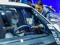 Visitors look at BYD's YANGWANG stand at the 2024 ASEAN International Auto Show in Nanning, China, on December 7, 2024. (