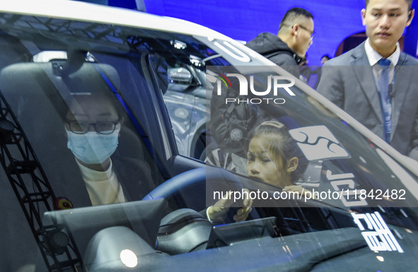 Visitors look at BYD's YANGWANG stand at the 2024 ASEAN International Auto Show in Nanning, China, on December 7, 2024. 