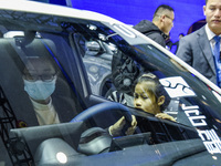 Visitors look at BYD's YANGWANG stand at the 2024 ASEAN International Auto Show in Nanning, China, on December 7, 2024. (