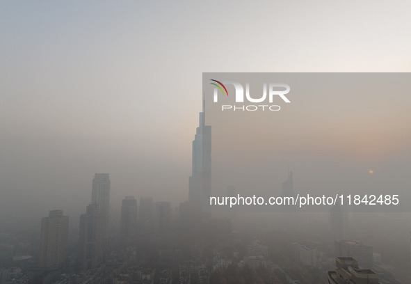 Buildings loom under heavy fog in Nanjing, Jiangsu province, China, on December 7, 2024. 