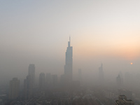 Buildings loom under heavy fog in Nanjing, Jiangsu province, China, on December 7, 2024. (