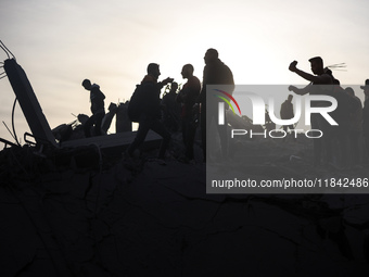 Palestinians inspect the damage after an Israeli strike on the Nuseirat refugee camp in the central Gaza Strip on December 7, 2024, amid the...