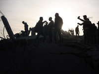 Palestinians inspect the damage after an Israeli strike on the Nuseirat refugee camp in the central Gaza Strip on December 7, 2024, amid the...