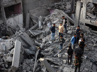 Palestinians inspect the damage after an Israeli strike on the Nuseirat refugee camp in the central Gaza Strip on December 7, 2024, amid the...