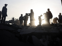 Palestinians inspect the damage after an Israeli strike on the Nuseirat refugee camp in the central Gaza Strip on December 7, 2024, amid the...