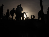 Palestinians inspect the damage after an Israeli strike on the Nuseirat refugee camp in the central Gaza Strip on December 7, 2024, amid the...