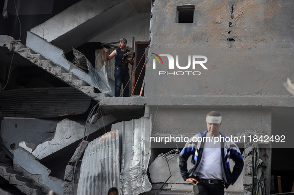 Palestinians inspect the damage after an Israeli strike on the Nuseirat refugee camp in the central Gaza Strip on December 7, 2024, amid the...