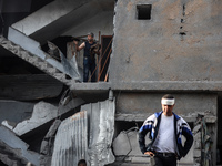 Palestinians inspect the damage after an Israeli strike on the Nuseirat refugee camp in the central Gaza Strip on December 7, 2024, amid the...